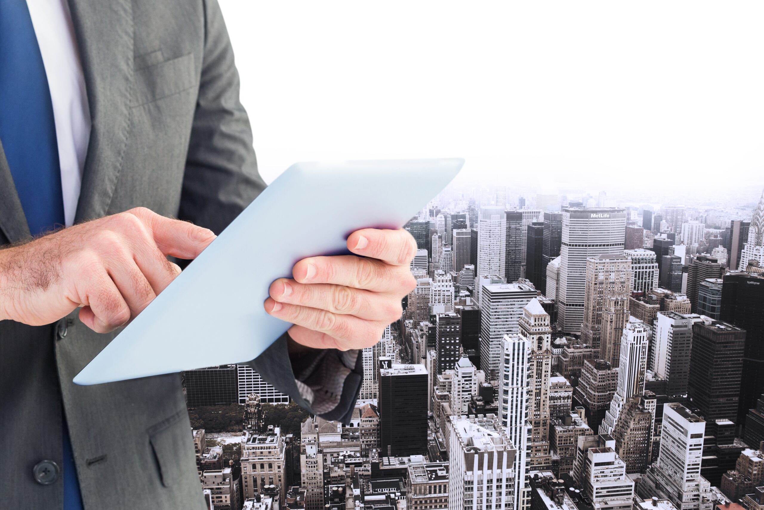 executive with tablet buildings background